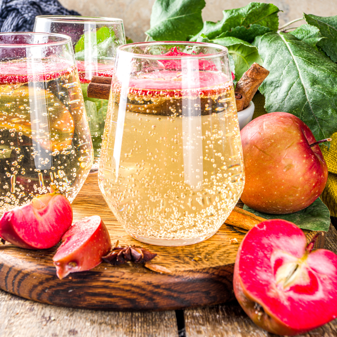glasses of bubbly cider with apples